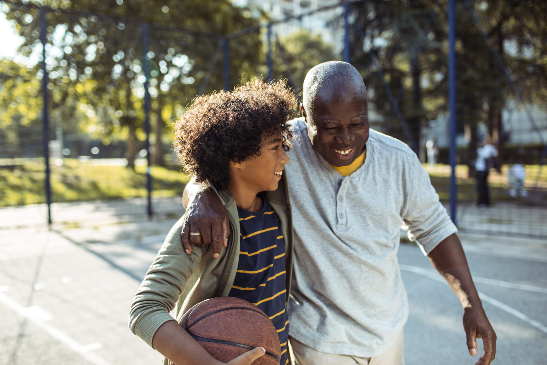 grandpa and grandson playing basketball