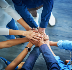 group of people joining hands