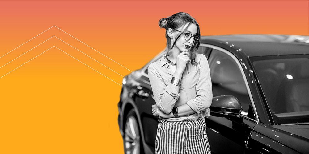 Woman with glasses and her hand on her chin looking at a car