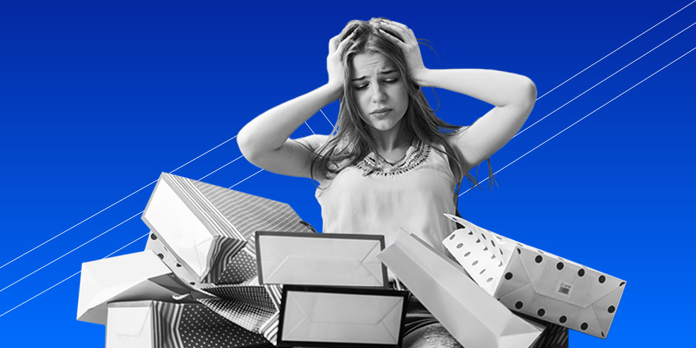 Woman holding her head while looking at shopping bags
