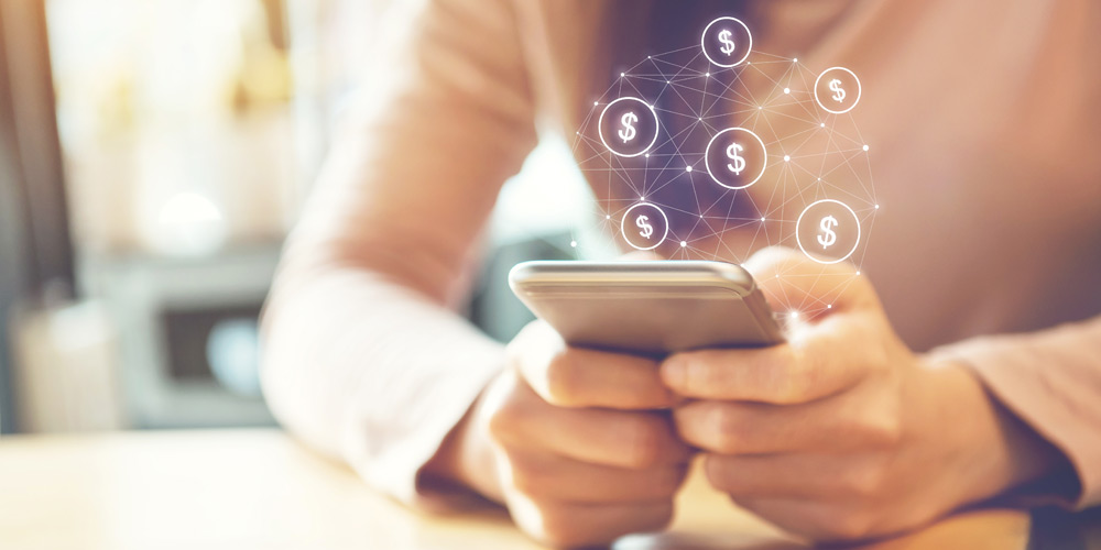 Woman holding a phone with dollar symbols