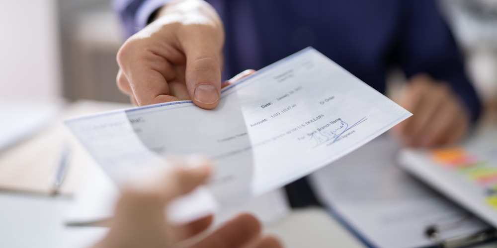 Man handing a check to someone