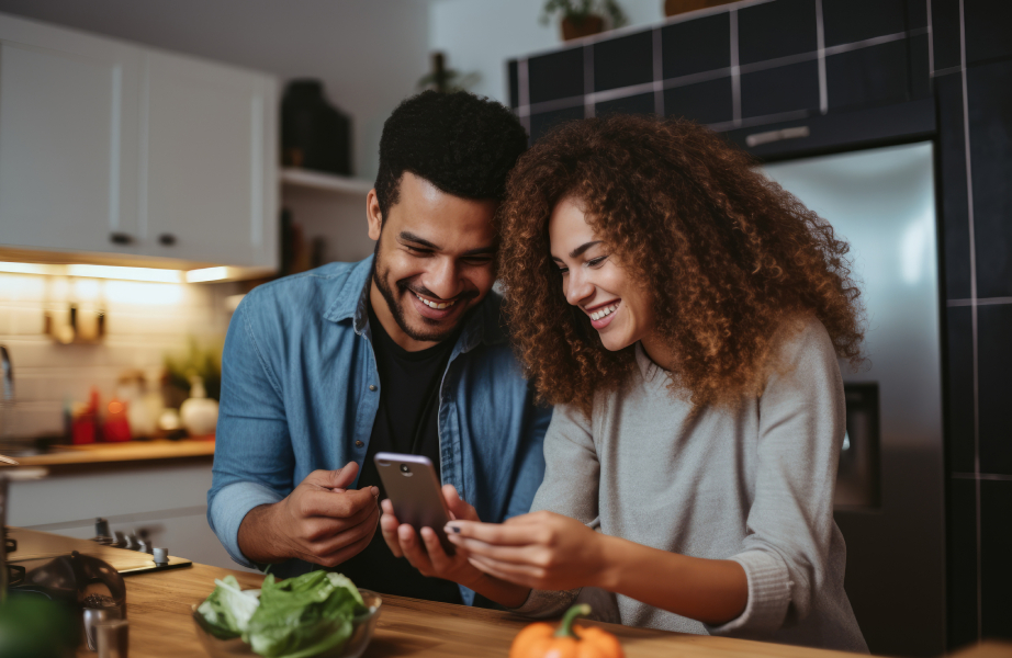 Couple In Kitchen On Phone
