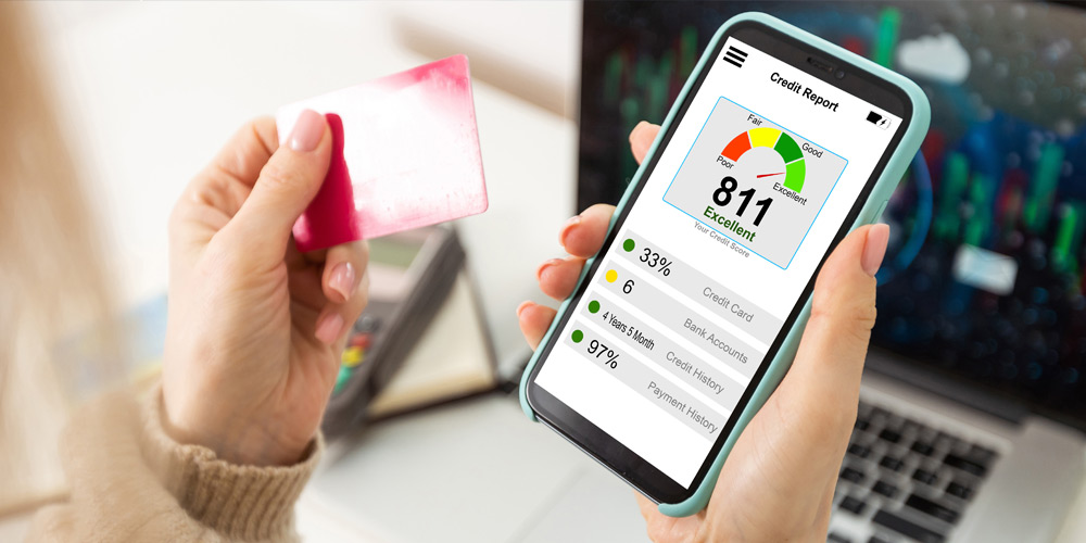 Hands holding a credit card and a phone