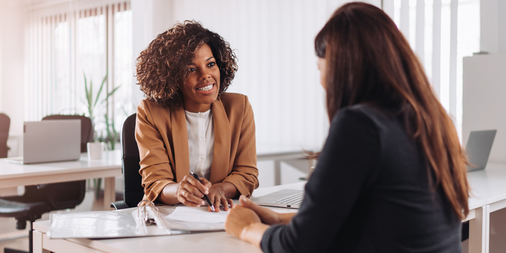Woman using a pen to point something out to her client