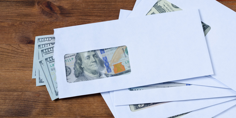 $100 bills in an envelope