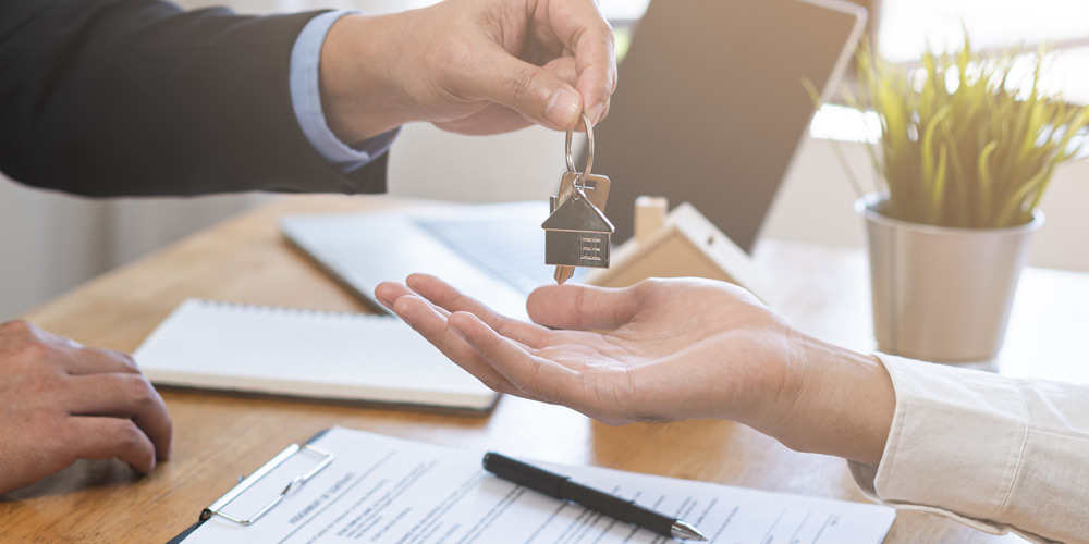 Hands exchanging house keys